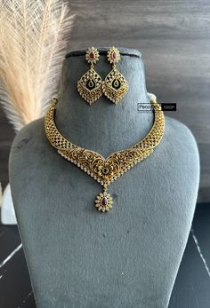 This Multicolor Cz Floral Golden Finish Necklace set is a classic choice for any wardrobe. Adorned with traditional South-Indian Temple jewelry, this necklace is an exquisite piece that is sure to impress. Crafted in high-quality materials, this necklace will last for years to come. It will come with Golden thread to tie Elegant Yellow Gold Brass Temple Necklace, Traditional Luxury Brass Temple Necklace, Gold Beaded Bollywood Temple Necklace, Luxury Gold Bollywood Temple Necklace, Gold-plated Bollywood Temple Necklace, Golden Thread, American Diamond Necklaces, Temple Jewelry, Oxidized Necklace