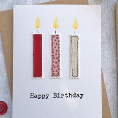 a birthday card with three candles on it