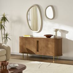 a living room with a couch, table and mirror