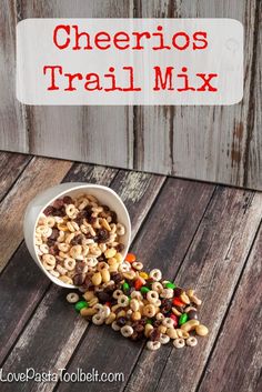 a white bowl filled with cheerios and cereal next to a wooden background that says cheetos trail mix