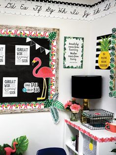 a blackboard with pink flamingos on it in the corner of a living room