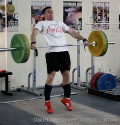 a man is doing an overhead barbell squat