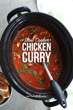 a slow cooker chicken curry is shown with bread on the side and in bowls next to it