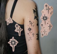 a woman's arm with stars and crosses on it