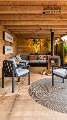 two chairs sitting on top of a rug next to a fire place