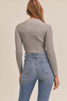 Meet your new favorite fall basic, the Current Mood Crop Sweater by WREN The Label. Soft ribbed knit shapes this comfy, sweater-inspired top. Her features include a mock neckline, cropped length and figure-skimming bodice, framed by long sleeves. Pair this top with your favorite jeans for a look you'll want to wear over and over again! Details Fabric: Ribbed Sweater Material. Long Sleeved. Mock Neckline. Cropped Length. Model is 5'7 | Wearing a S 52% Viscose 20% Nylon 28% Polyester Fitted Soft Knit Cropped Sweater For Fall, Fall Ribbed Crew Neck Cropped Sweater, Winter Ribbed Stretch Cropped Sweater, Spring Soft Knit Cropped Top, Spring Soft Knit Cropped Crop Top, Solid Color Cropped Knit Top, Ribbed Turtleneck Knit Top For Fall, Fall Ribbed Turtleneck Knit Top, Ribbed Stretch Cropped Sweater For Winter