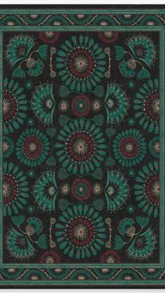 a black and green area rug with an intricate design on the center, surrounded by flowers