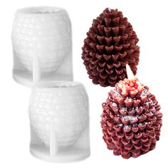 three pine cones sitting next to each other on top of a white surface with frosting