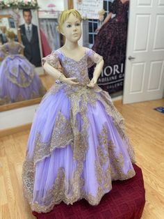 Mini Quinceañera dress Lilac/Gold. This is the mini version of style PR30118 from the Princesa Collection by Ariana Vara. You may request your mini version from any of the Quinceañeras collection such as Princesa, MORI LEE and House of Wu. Please email us for more details. Please note that fabric colors may be slightly different from each monitor and in person. Elegant Short Sleeve Pageant Gown, Elegant Purple Pageant Dress, Elegant Purple Dress-up Gown, Elegant Purple Gown For Dress-up, Quince Lilac, Dress Lilac, Mori Lee, Lilac Dress, Quinceanera Dresses