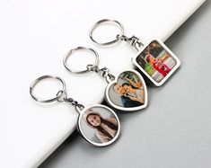 three key chains with pictures on them