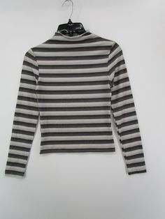 Winter Striped Stretch Tops, Striped Stretch Tops For Winter, Striped Stretch Turtleneck Top, White High Neck Cotton Top, Trendy High Neck Top, White Ribbed Funnel Neck Top, White Stretch Tops With Ribbed Collar, Fitted Striped Tops With Ribbed Collar, Striped Crew Neck Top For Winter