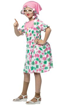 a woman in a pink and green dress is giving the peace sign with her hand