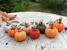 several pumpkins are sitting on top of each other in the shape of key chains