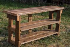 a wooden bench sitting on top of a lush green field