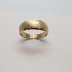 a close up of a gold ring on a white surface