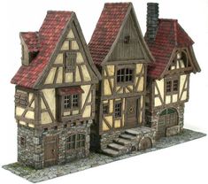 a model of a house with red roof and windows