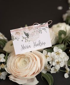 a close up of flowers with a name tag on it