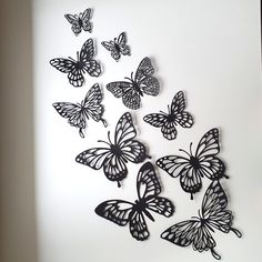 a group of black and white butterflies on a wall