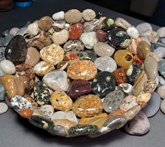 a bowl filled with lots of rocks on top of a table