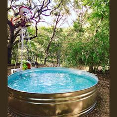 an above ground swimming pool surrounded by trees