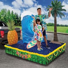 a man and girl standing on top of a float