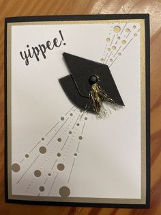 a graduation card with a graduate's cap and tassels on the front