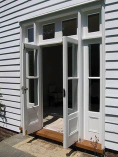 an open white door on the side of a house