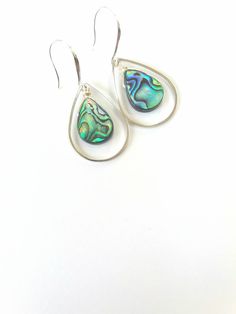 These beautiful earrings are made from real abalone shells. These abalone earrings are durable, lightweight and very elegant. They will make a perfect gift for someone special in your life or just because you deserve it! Each shell is unique, therefore, please expect a small variation from the shell on the photographs. Ear-wires on these earrings are 925 sterling silver. Each item is carefully packaged in an elegant jewelry box ready as a gift. If you would like to add a personalized note with y Mother Of Pearl Teardrop Jewelry With Matching Earrings, Mother Of Pearl Teardrop Jewelry Set, Teardrop Mother Of Pearl Jewelry For Anniversary, Handmade Mother Of Pearl Teardrop Earrings, Iridescent Teardrop Earrings For Wedding, Abalone Shell Dangle Jewelry, Handmade Teardrop Abalone Shell Jewelry, Nickel-free Abalone Shell Drop Earrings, Abalone Shell Drop Earrings