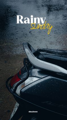 the front end of a motor scooter with rain and water in the background