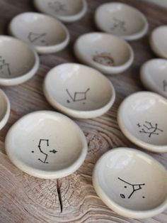 several bowls with faces drawn on them sitting on a table