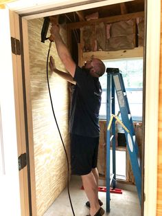 a man is using a power drill to install insulation