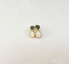 Dainty and rustic, yet elegant, these exquisite stud earrings feature a beautiful pairing of raw green Emerald and Australian Opal, delicately handcrafted into a unique and one-of-a-kind design. Perfect as bridal earrings on that very special day, or to add a touch of elegance to your everyday wear - these earrings will make a unique gift for a loved one born in either May or October.T H E ∙ S M A L L ∙ D E T A I L S• Raw green Emerald (5-6mm)• Teardrop shape Australian Opals (6-8mm)• 14k Gold f Unique Bridal Earrings, Opal Stud Earrings, Raw Emerald, Opal Earrings Stud, Opal Studs, May Birthstone, Emerald Necklace, Birthstone Gifts, Green Gemstones