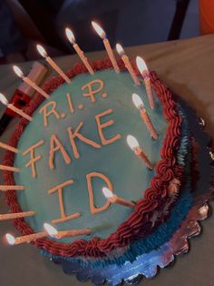 a birthday cake with lit candles on it that says rip fake d'od