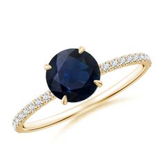 an oval blue sapphire and diamond ring with two rows of diamonds around the band, set in yellow gold