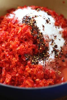 a bowl filled with red rice and seasoning