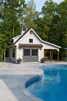 an outdoor pool with a gazebo next to it and a shed in the background