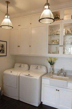 a washer and dryer in a white kitchen