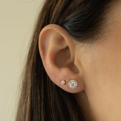 These cubic zirconia stud earrings featuring a pavé halo sparkle so bright! They are so elegant and work great for everyday first-hole studs or as wedding or bridesmaid earrings. Absolutely beautiful! We also use the highest grade of cz for an authentic diamond look! They look like real diamonds 🤩 - - -  D E T A I L S - - -  * Made of 925 Sterling Silver * We use a THICK plating of 14k Gold or Rhodium * Nickel-free & Hypoallergenic (safe for sensitive ears!) * Sold as a pair  * 7mm Diameter * Push-back closure Earrings on Model ----> 3.4mm Bezel Studs https://www.etsy.com/listing/1449220204/bezel-earring-studs-hypoallergenic?click_key=1f1bc59b800bfa52646c56483dfa9668bdf9c6c0%3A1449220204&click_sum=928f637d&ga_search_query=bezel%2Bstuds&ref=shop_items_search_7&pro=1&frs=1&sts=1 Comes in a Cubic Zirconia Round Cut Cluster Earrings For Wedding, Classic Diamond White Flower Earrings For Gift, Classic Diamond White Flower Earrings As Gift, Diamond White Flower Earrings With Cubic Zirconia, Classic Round Flower Earrings For Anniversary, Cluster Earrings With Cubic Zirconia As Gift, Round Cut Cluster Earrings With Prong Setting For Wedding, Fine Jewelry Flower Earrings With Diamond Accents For Wedding, Dainty Diamond White Diamond Earrings For Wedding