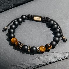 24/7 Customer Service Free United States Shipping 1 Year Warranty on All Products Adjustable Size Handmade with Care 8 mm Onyx Beads 8 mm Tiger Eye Beads Black Crystals Sometimes, whether in our work life or our relationships, it can feel like we’re walking a tight rope. Adopting the energy of Onyx let’s you breathe easier, giving you the balance, confidence and protection to take the next step. Tiger’s Eye helps you to see through a fresh set of eyes, so that you can gain clarity on situations that have become blurry or confusing. Tiger’s eye shifts your outlook so that you can gain a deeper understanding of yourself. Gold Beads Bracelet, Hamsa Bracelet, Black Onyx Bracelet, Lapis Lazuli Bracelet, Zodiac Bracelet, Red String Bracelet, Tiger Eye Bracelet, Gold Bead Bracelets, Onyx Bracelet