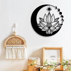 a wooden shelf topped with vases and pictures next to a wall mounted art piece