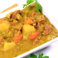 a white bowl filled with stew and vegetables