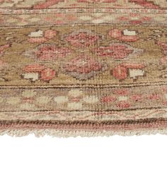 an old rug with faded colors and fringes