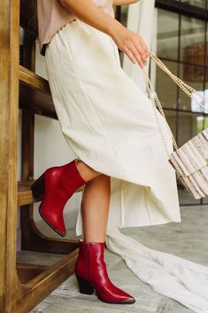 Make a bold statement with the Frankie Western Ankle Red Boot. Designed with a striking red snake faux leather upper, this boot exudes a fierce, fashion-forward edge. The Western-inspired silhouette is enhanced by a steel pointed toe, giving it a sleek, modern twist. A sturdy block heel adds height and stability, while the monochrome inside zipper ensures easy wear. Whether you're adding a pop of color to a casual look or elevating a night-out ensemble, the Frankie Boot is your go-to for fearles Cowgirl Booties Outfits, Snake Boots, Fierce Fashion, Red Snake, Booties Outfit, Faux Leather Purse, White Bodycon Dress, Travel Dress, Red Boots