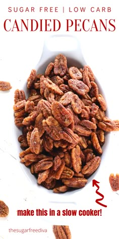 a white bowl filled with candied pecans on top of a table