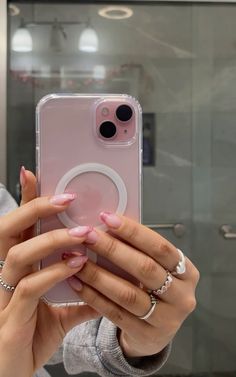 a woman taking a selfie with her cell phone in front of her face and hands