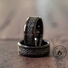 two wedding rings sitting on top of each other