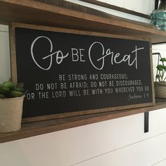 a sign that says go be great on the side of a shelf with succulents