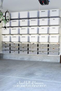 there is a bike hanging from the ceiling in front of several bins on shelves