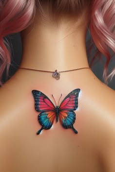 the back of a woman's neck with a butterfly tattoo on her upper part