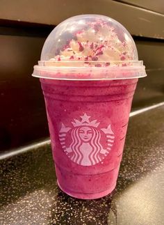 a pink starbucks drink with sprinkles on top